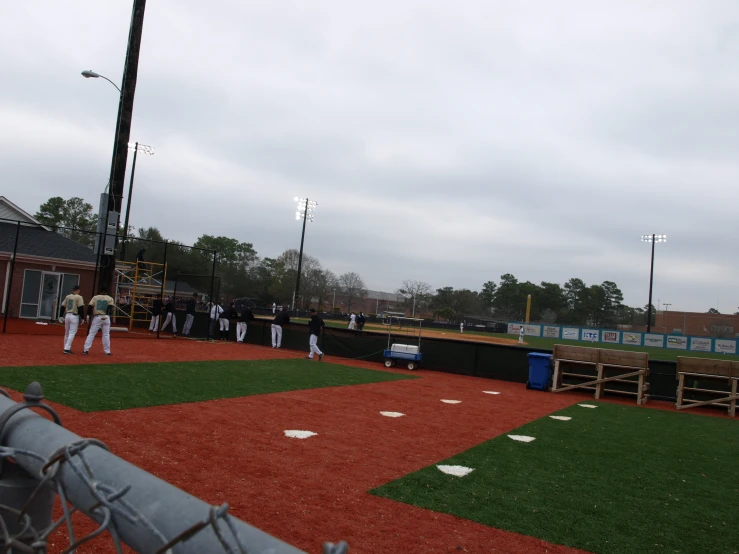 a group of people in white suits playing baseball