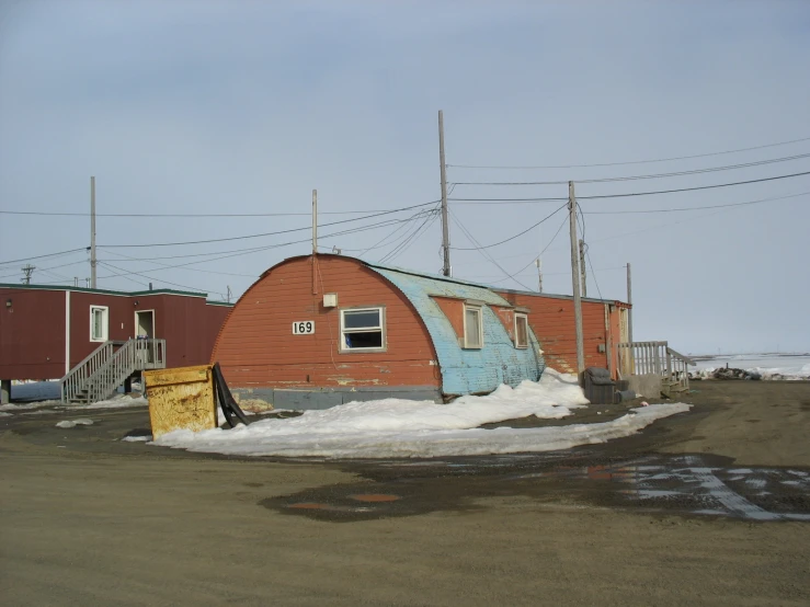 an orange shack with graffiti on it and no windows