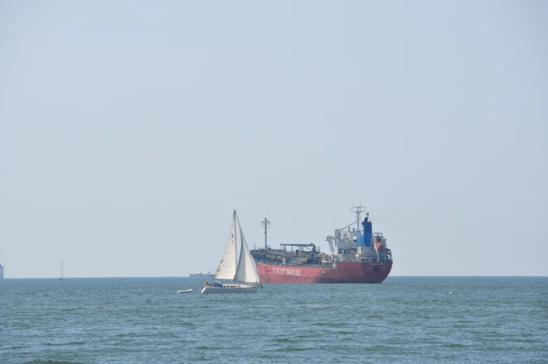 two boats in the water near a large ship