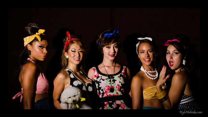 a group of girls in costumes posing together