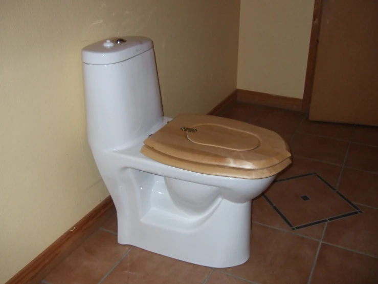 a toilet with a wooden seat in a room