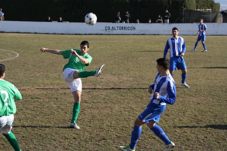 several people are playing soccer in a field