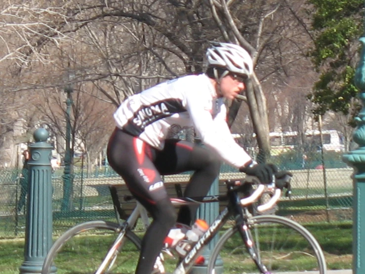 a man riding a bike down the side of a street