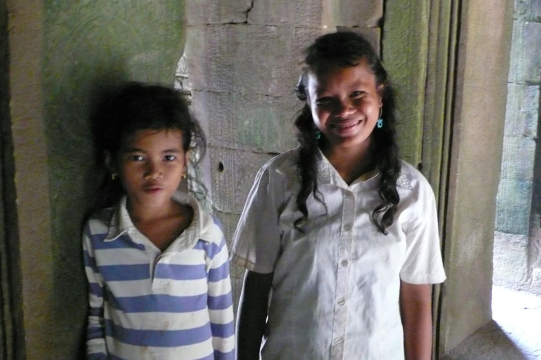 a couple of young ladies standing next to each other