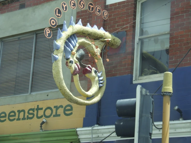 a store front with a very pretty dragon statue on the side