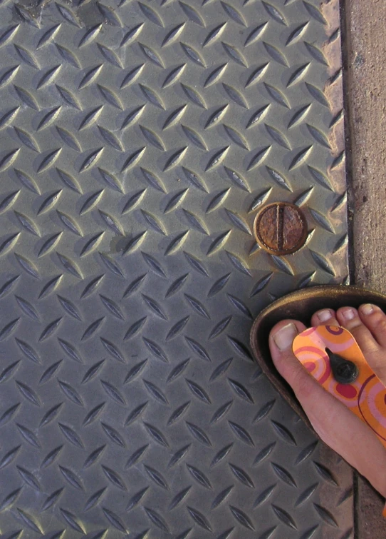 a persons feet are shown next to a diamond shaped surface