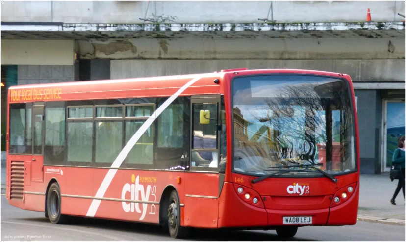 a city bus on the road and passengers waiting to get on it