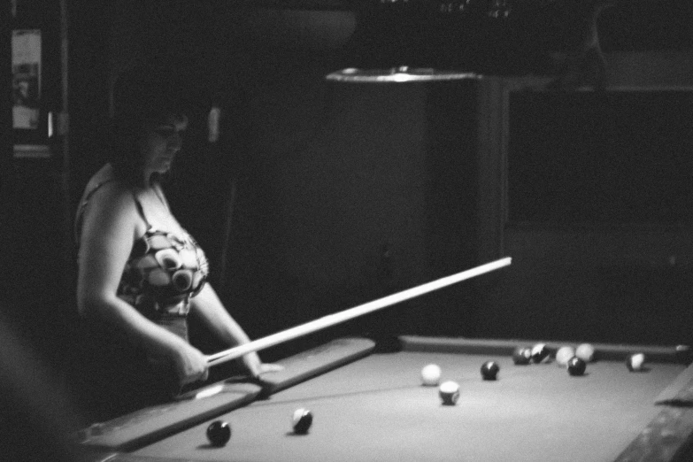 a young woman playing a game of pool