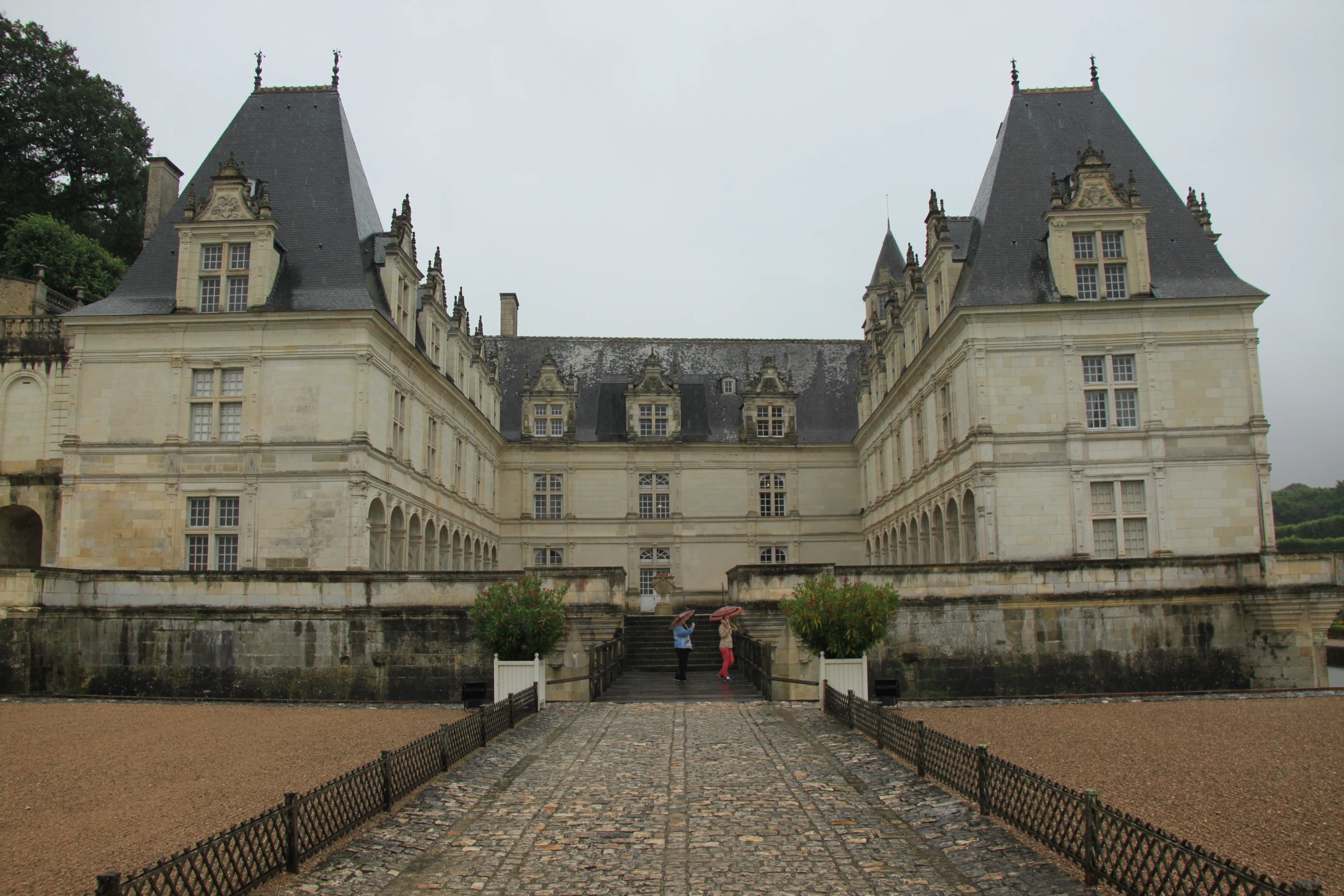 a large castle like building surrounded by a stone garden