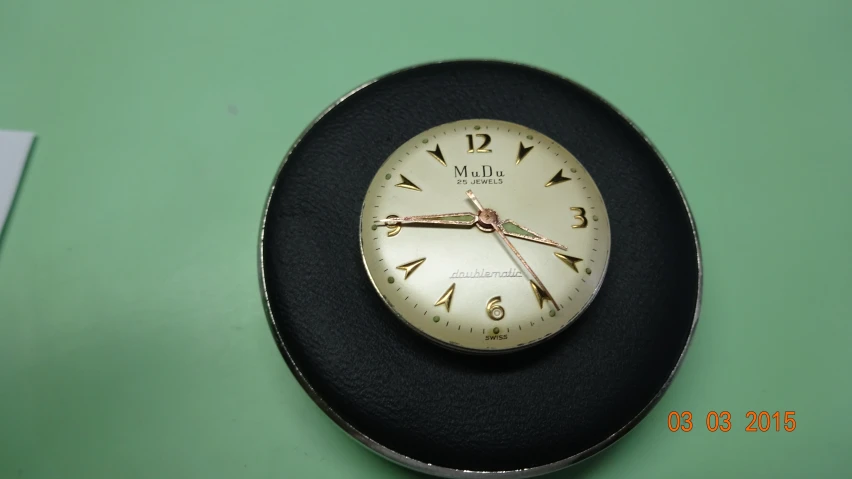 a black plate with a clock face and numbers