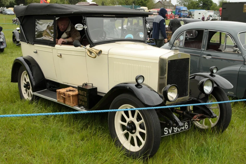 vintage cars at a vintage car show on grass