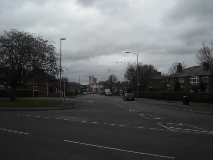 a street filled with lots of traffic under cloudy skies