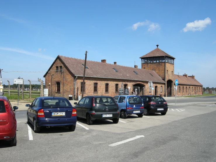 many cars parked outside an old brick church