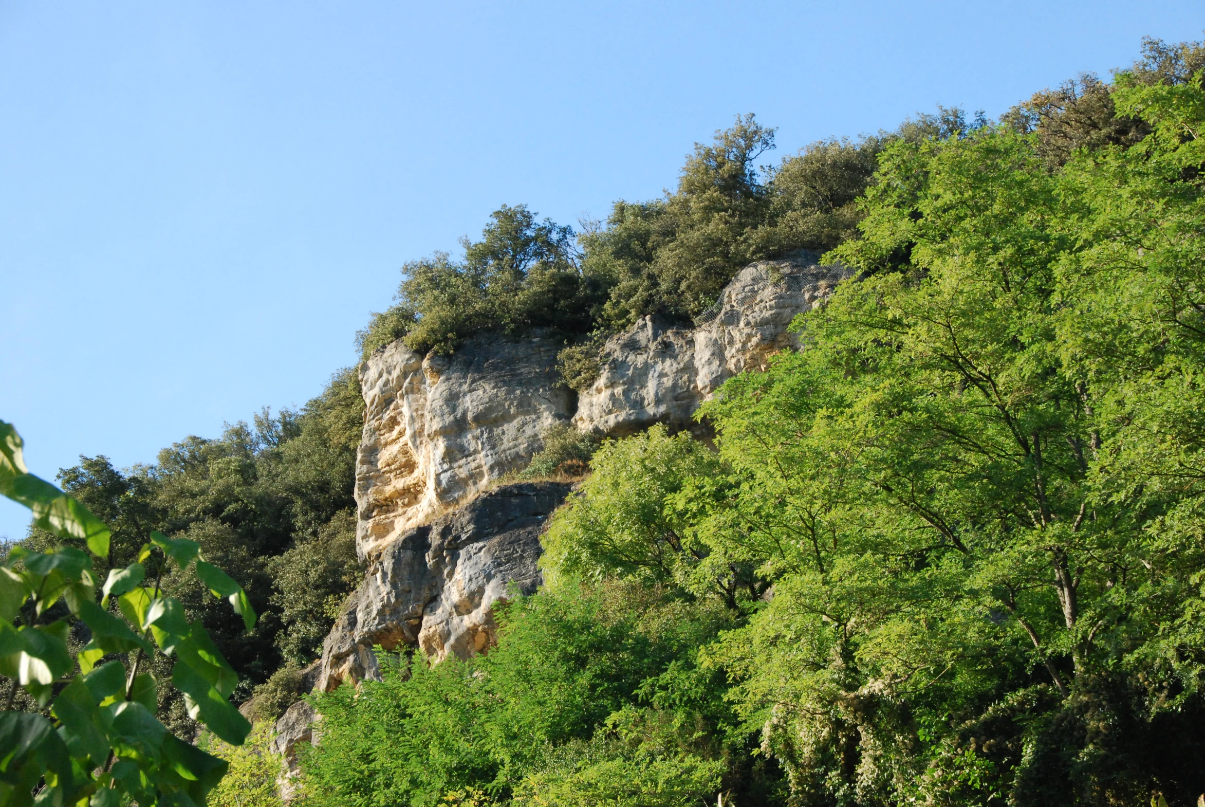 an area where the cliffs are in deep green foliage