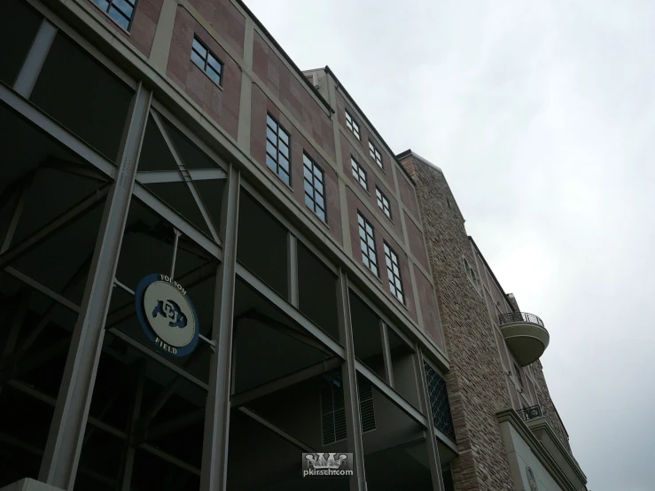 an entrance to the building has a large clock displayed