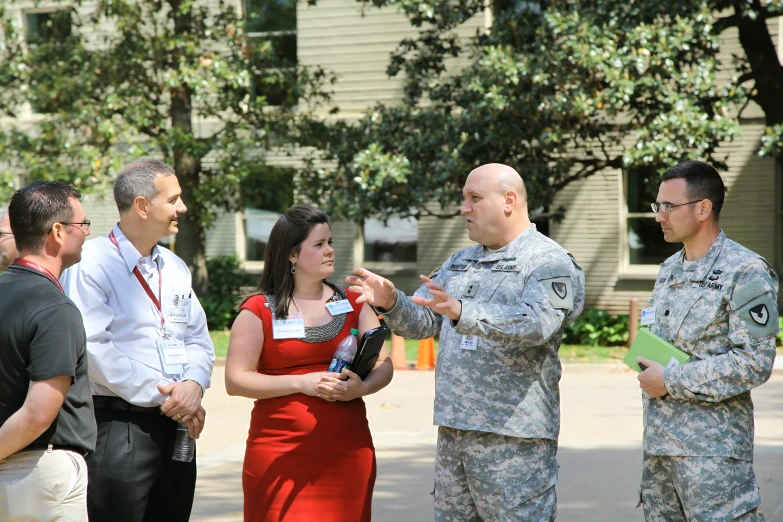 two men and two women talking to soldiers