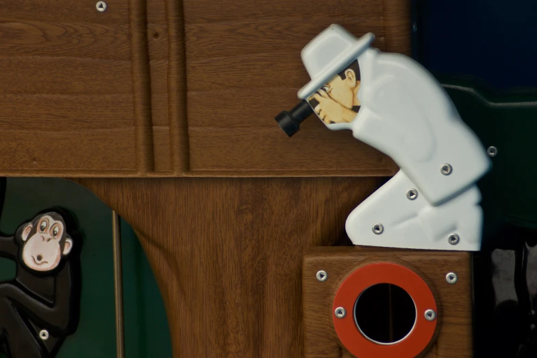 a white hand held object on top of wooden shelf