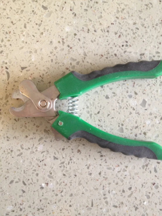 an open metal scissors resting on a speckled surface