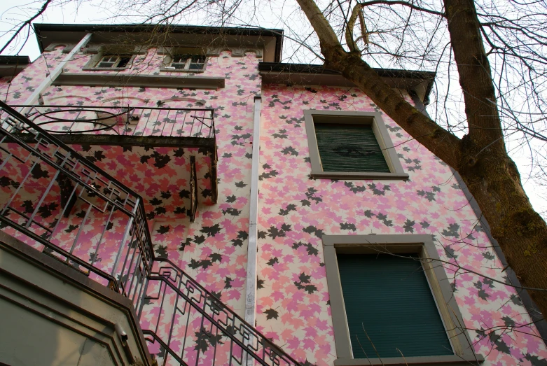 a pink building that has lots of windows on it