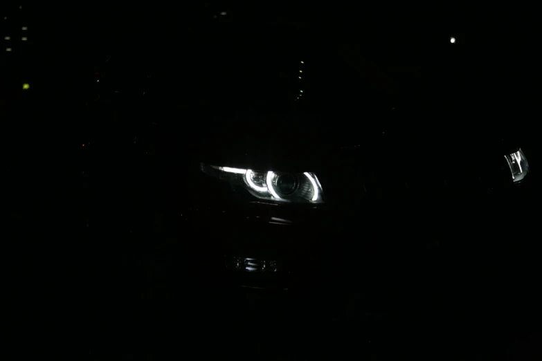 the lights of a car and its headlight in the dark