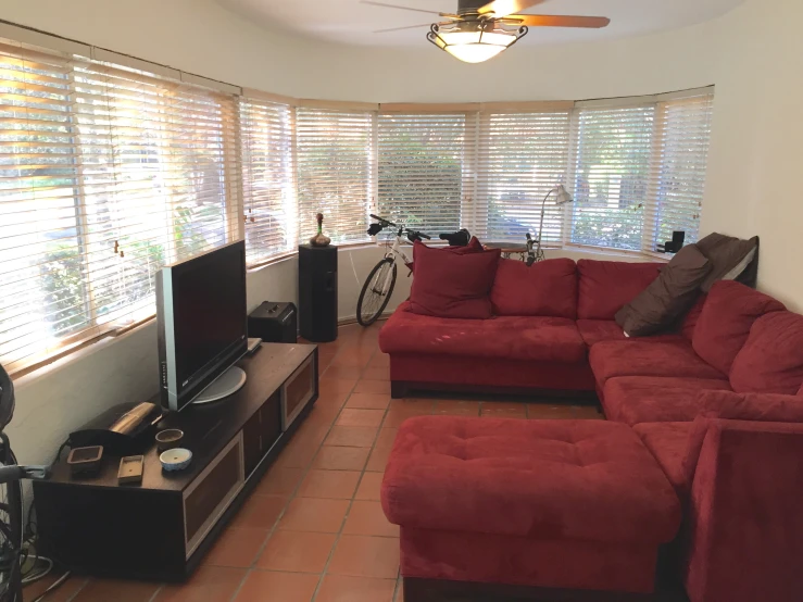 the living room has many pillows and a television