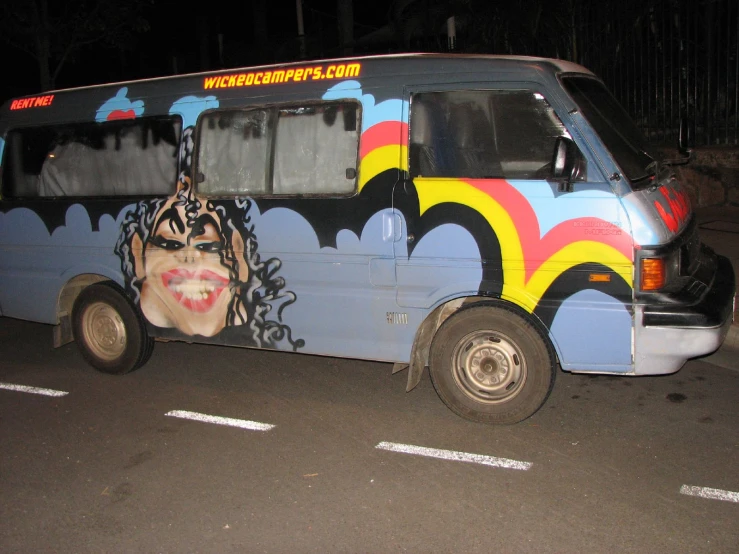 a brightly colored bus with faces painted on it