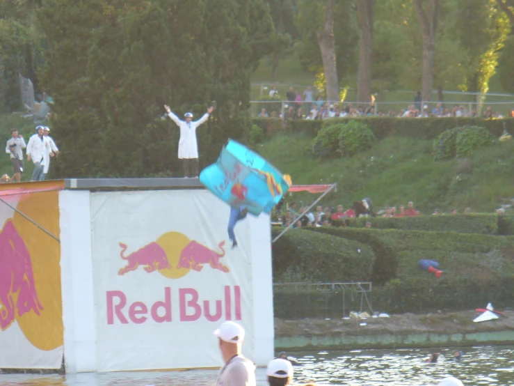 a guy on a ledge flying a colorful kite