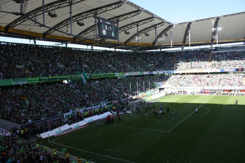 a crowd of people watching a soccer match