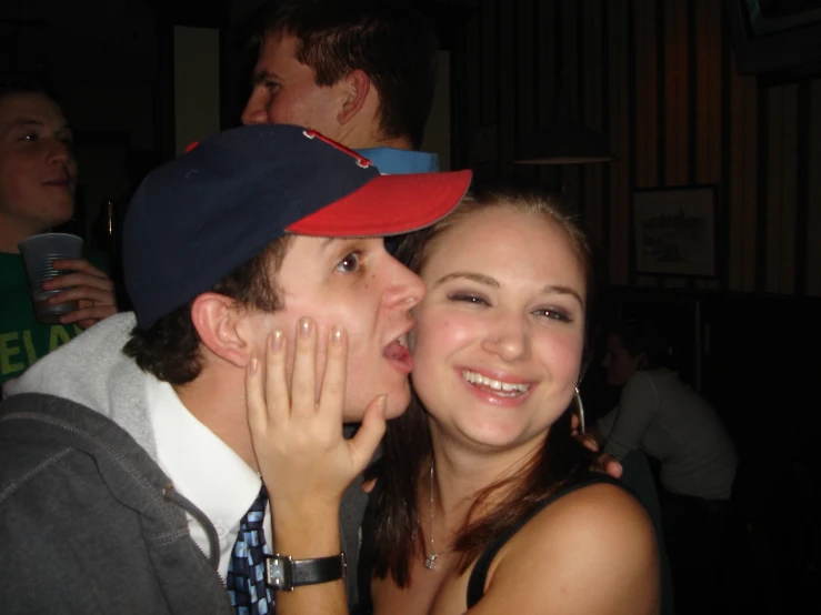 young man kissing and kissing a smiling young woman