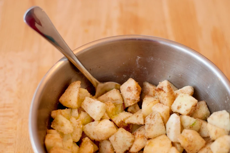 chopped up cubes in a bowl with a spoon