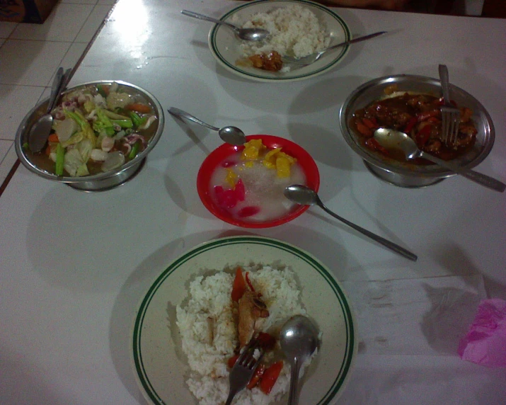 several small bowls of food are arranged on top of the table