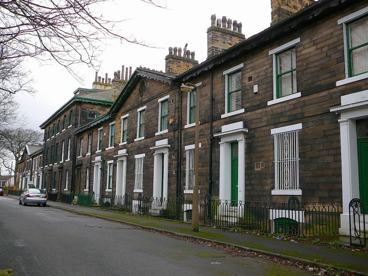 a row of brick buildings with green shutters