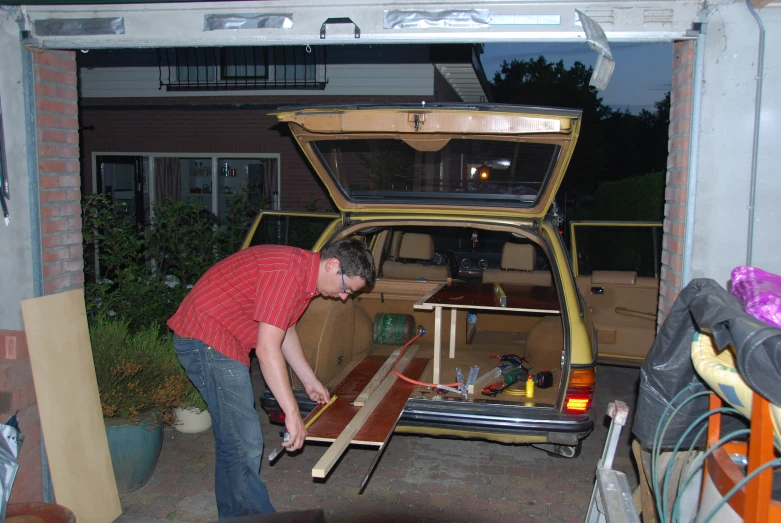 a person standing over a brown wooden table