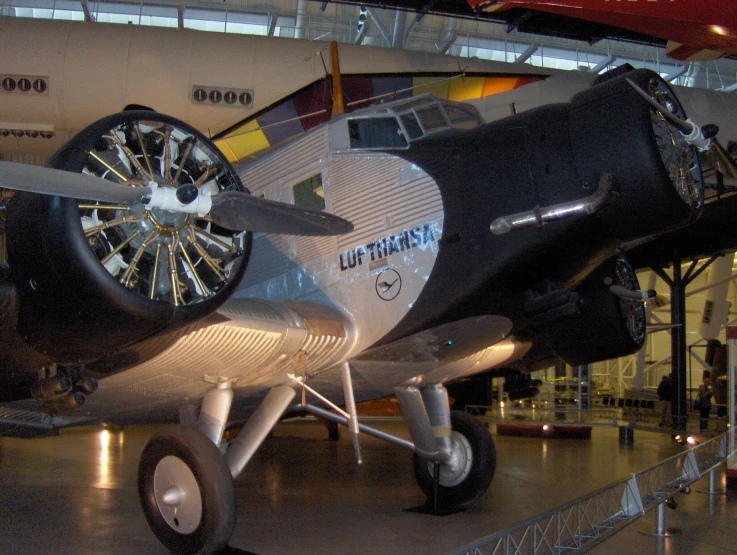 an old airplane on display in a large building