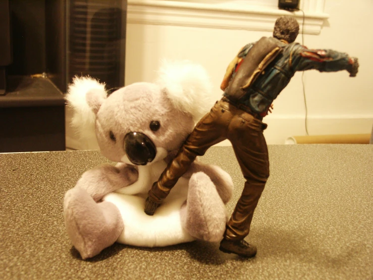 a toy bear sits on top of a table