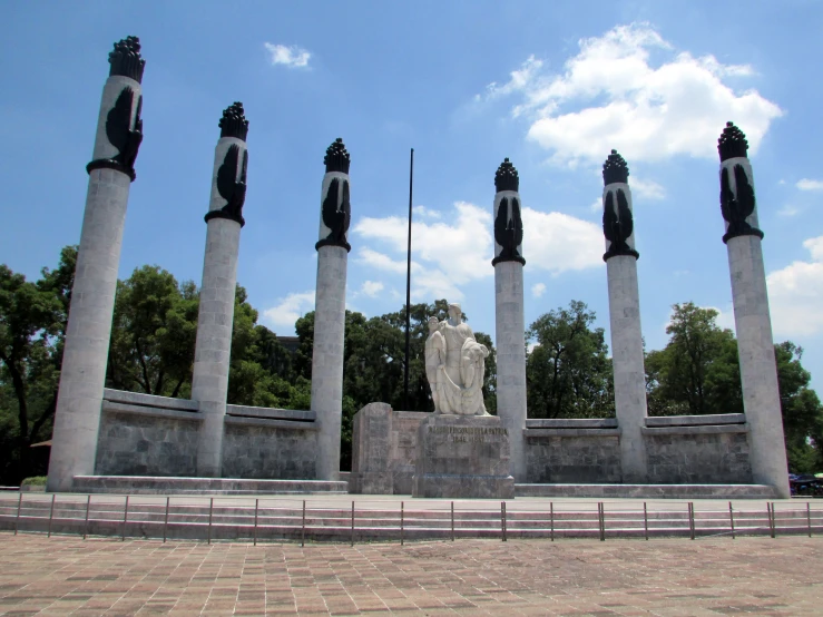 the monument has five marble pillars and a large sculpture