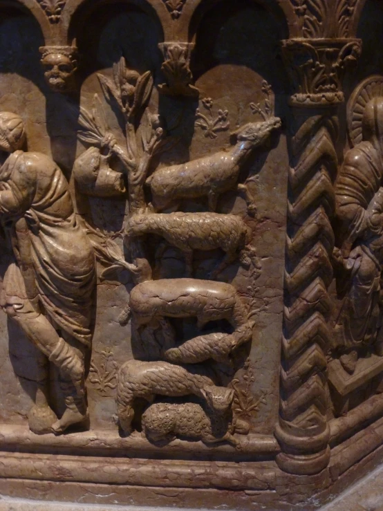 an ancient relief featuring women holding deers