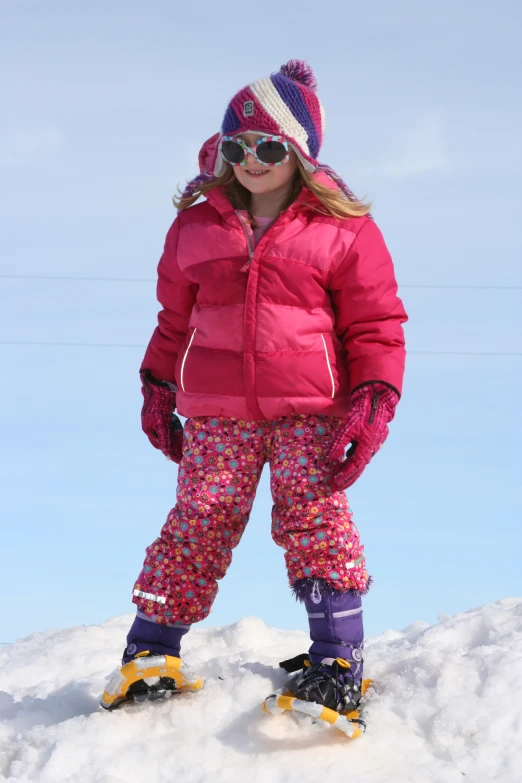 a  stands on a snow slope wearing snow skis