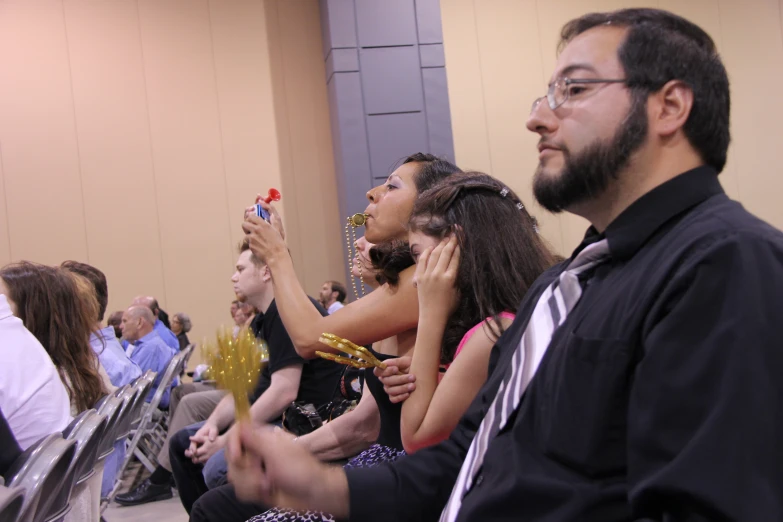 a group of people are gathered and raising their hands