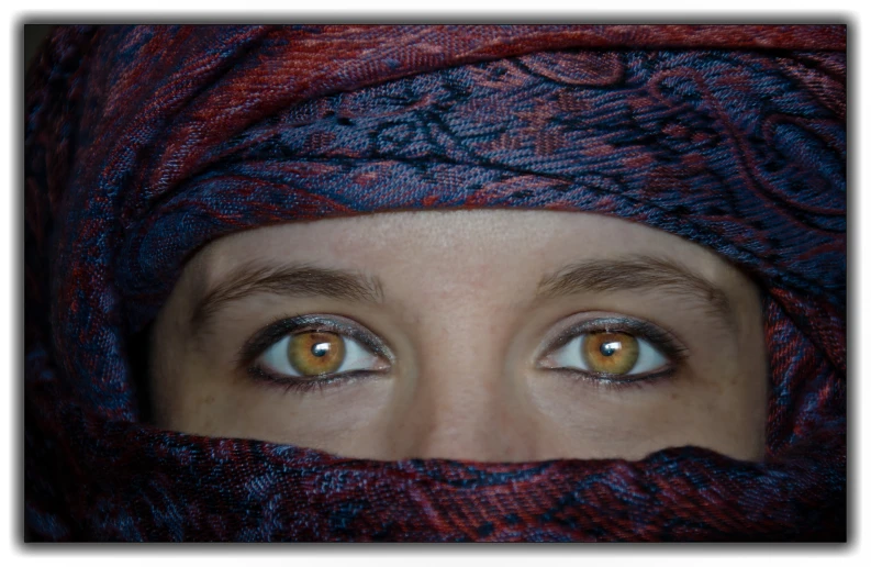 woman with eyes covered by an intricate design, covering her face