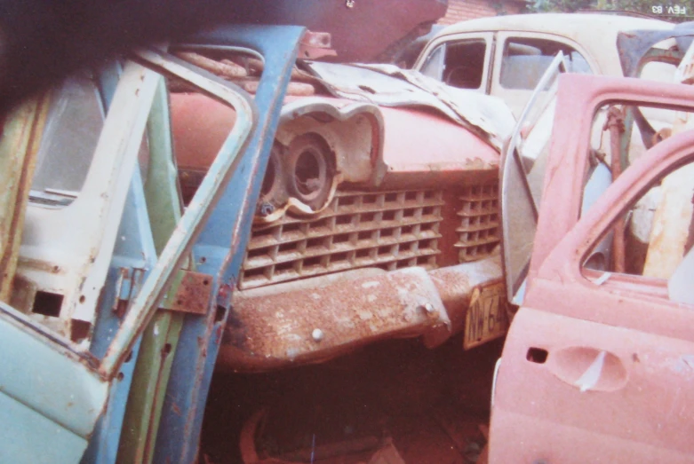 several old car parts sit in a pile