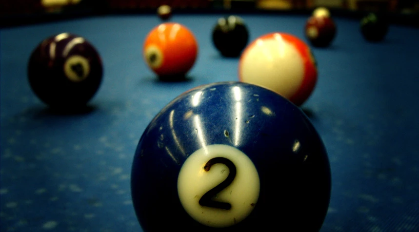 a group of billiards lined up on a pool table