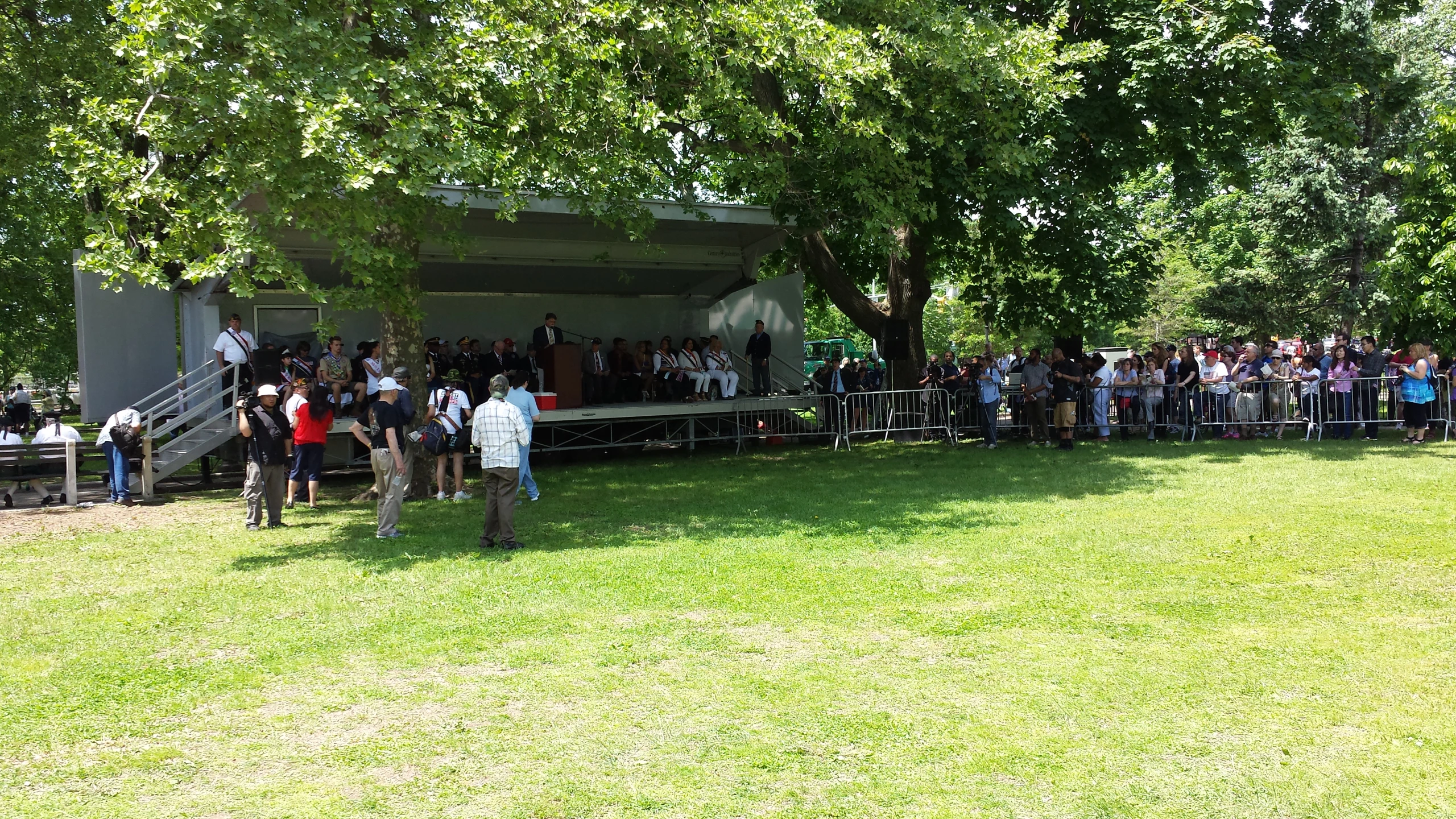 large crowd of people in an open area by a house