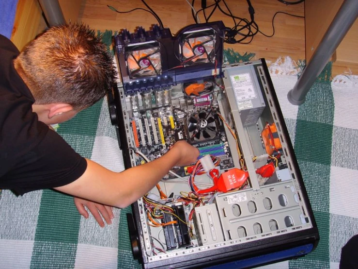 a man that is looking at a small electronic equipment