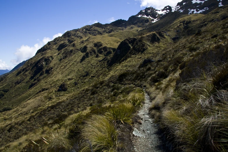 a dirt path going down a side of a mountain