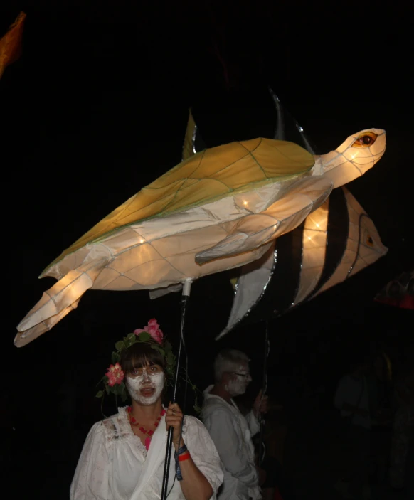 a person dressed as an unknown creature holding a staff