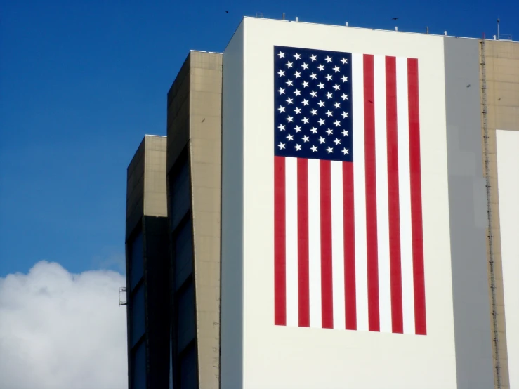 an american flag on a building in the day light