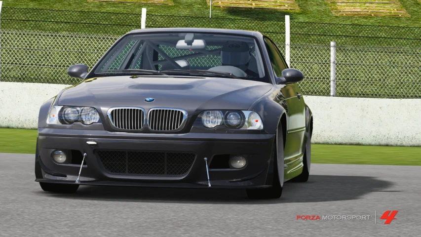 a bmw e36 car drives through a track