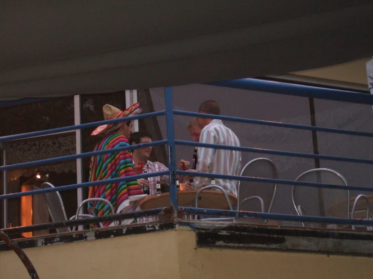 men sitting on the railing and having drinks