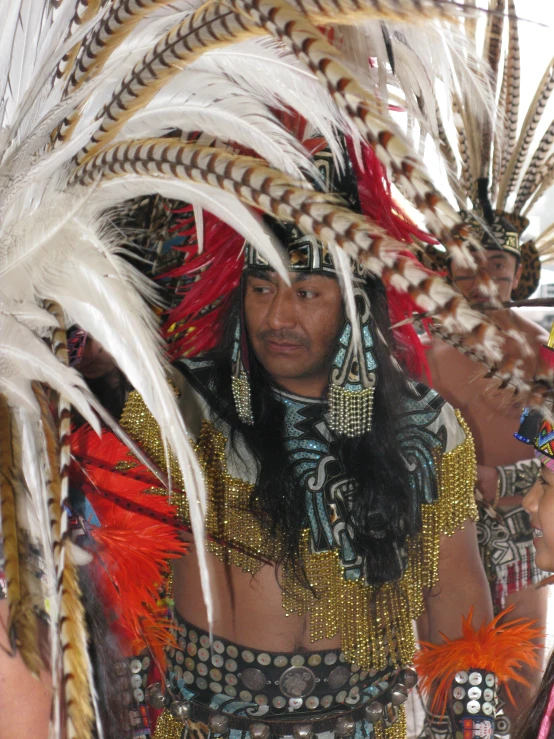 a native american man with feathers on his head